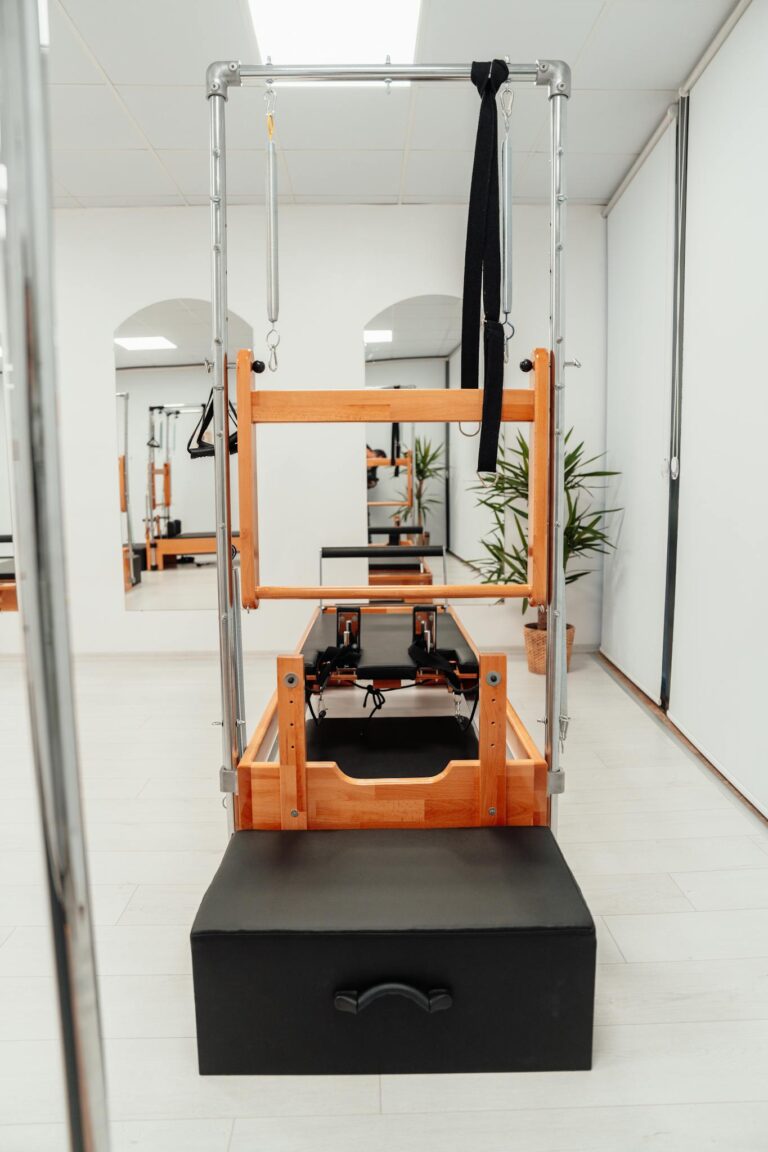 Pilates reformer machine in a clean, modern studio perfect for fitness enthusiasts.